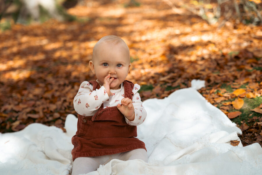 Lachendes Baby im Herbstlaub